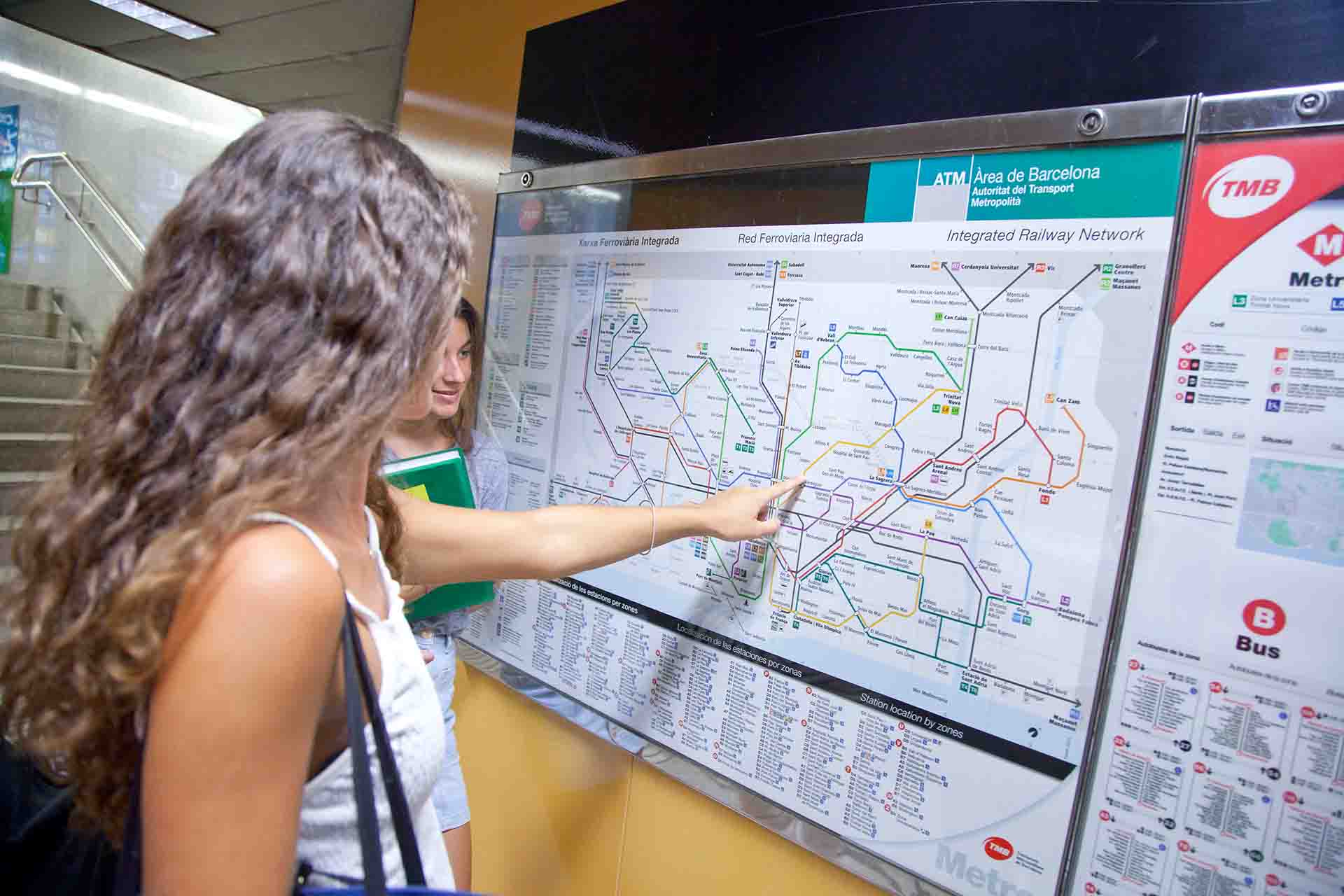 Two girls look at the integrated transport map.