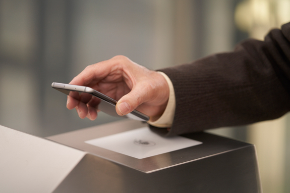 A person brings her mobile near by the contactless sensor.